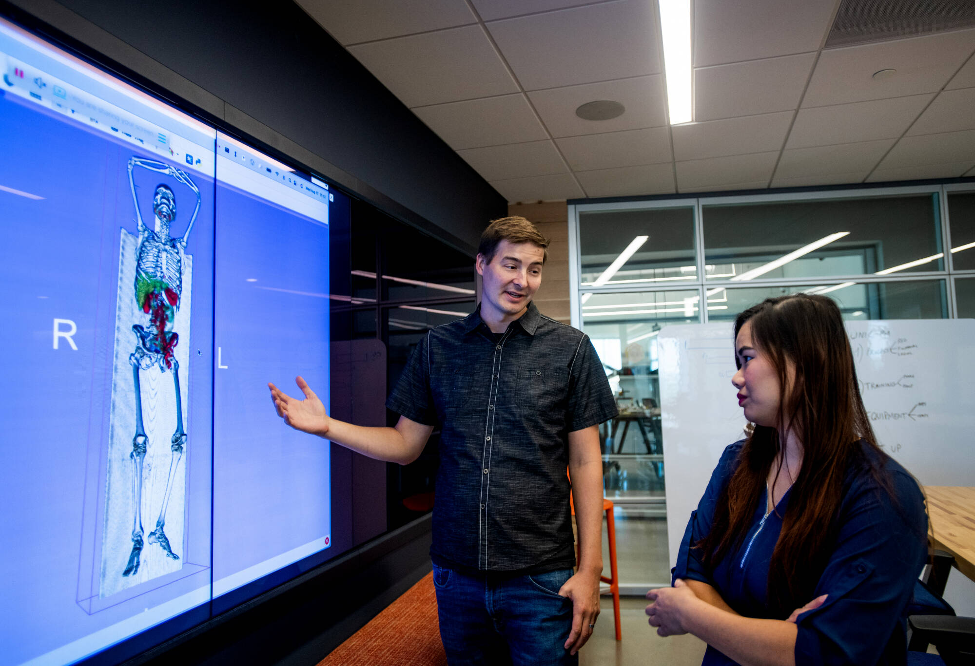 Jeff VanOss and Diana McCrumb, BAMF research engineers, stand in front of the results of a 3D scan at the BAMF Health headquarters in Grand Rapids. Both are biomedical engineering graduates from Grand Valley. (Photo releases on file)